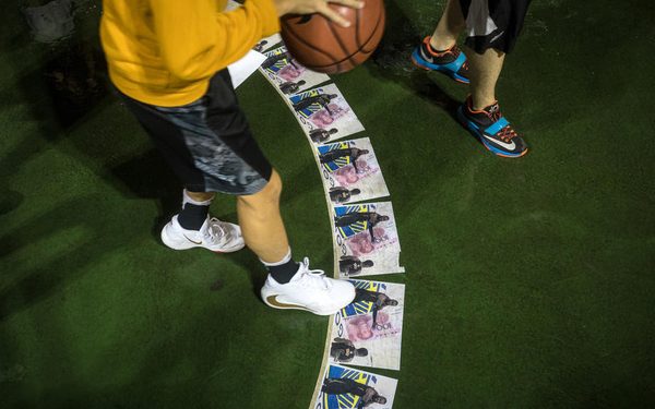 epa07923000 Protesters shoot hoops while stepping on  portraits of basketball player LeBron James, during a rally in support of Houston Rockets manager Daryl Morey and against James in Hong Kong, China, 15 October 2019. Both NBA personalities have made comments on twitter regarding the protests in Hong Kong and its relationship with China in the last week, leading to both praise and outrage from different camps. Hong Kong has been gripped by mass demonstrations since June over a now-withdrawn extradition bill, which have since morphed into a wider anti-government movement.  EPA-EFE/VIVEK PRAKASH