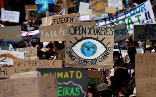 People hold up signs as they take part in a climate strike after the five-day Summer Meeting in Lausanne Europe (SMILE) of the Fridays for Future movement in Lausanne, Switzerland August 9, 2019. REUTERS/Denis Balibouse