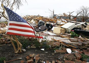 epaselect epa05082648 A US flag flies among the debris of an apartment building, in Garland, Texas, USA, 28 December 2015, after it was damaged on 26 December 2015 when a string of tornados ripped through Garland. A large weather system packing snow, ice and heavy rain hammered the mid-section of the United States on 28 December 2015 following a weekend of violent weather that claimed 43 lives in seven states. Entire residential areas near Dallas were turned into rubble heaps by tornadoes that devastated a corridor several kilometres long. Four districts have been declared disaster areas.  EPA/MIKE STONE