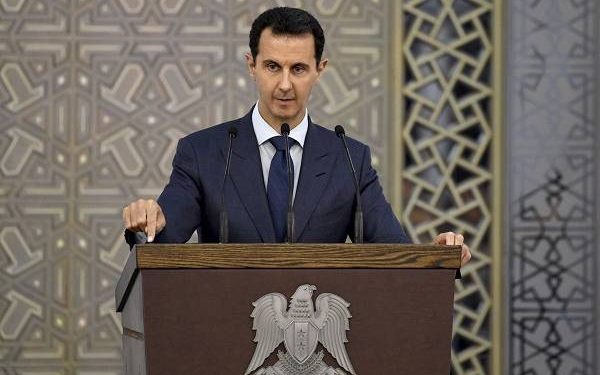 In this photo released by the official Facebook page of the Syrian Presidency, Syrian President Bashar Assad speaks to Syrian diplomats, in Damascus, Syria, Sunday, Aug. 20, 2017. In defiant comments Sunday, Assad blasted the West, rejecting any security cooperation or reopening of embassies in Damascus before those countries cut relations with opposition groups. In the speech, Assad praised Russia, Iran, China and Lebanon's Hezbollah for supporting his government. (Syrian Presidency Facebook page via AP)