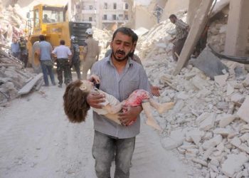 EDITORS NOTE: Graphic content / A Syrian man carries the body of a child following a reported Syrian government forces bombing at the Tariq al-Bab neighbourhood in the rebel-held area of the northern city of Aleppo on June 20, 2016.
The Syrian war has killed more than 280,000 people.

 / AFP PHOTO / THAER MOHAMMED