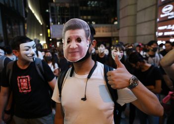 epa07962563 A protester wearing a mask of Chinese President Xi Jinping gestures during a Halloween rally in Lan Kwai Fong, a bar district in Central in Hong Kong, China, 31 October 2019. Hong Kong has entered a fifth month of ongoing mass protests, originally triggered by a now withdrawn extradition bill to mainland China that have turned into a wider pro-democracy movement.  EPA-EFE/JEROME FAVRE