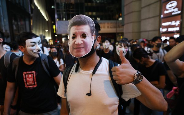 epa07962563 A protester wearing a mask of Chinese President Xi Jinping gestures during a Halloween rally in Lan Kwai Fong, a bar district in Central in Hong Kong, China, 31 October 2019. Hong Kong has entered a fifth month of ongoing mass protests, originally triggered by a now withdrawn extradition bill to mainland China that have turned into a wider pro-democracy movement.  EPA-EFE/JEROME FAVRE