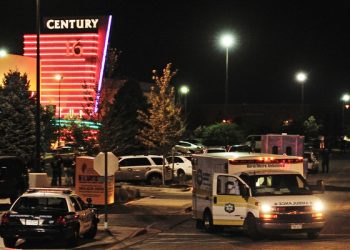 epa03312104 epa03312099 An ambulance is parked outside the Century 16 Theater in the Town Center Mall in Aurora, Colorado, USA early 20 July 2012, after a gunman killed 14 people and wounded 50 in a shooting incident at the premiere of the latest Batman movie 'The Dark Knight Rises'.  EPA/BOB PEARSON RE-CROPPED VERSION