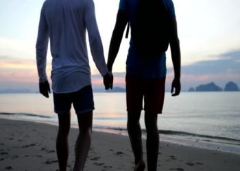 Gay Couple Walk On Beach At Sunset Holding Hands, Back Rear View Two Man Slow Motion 60