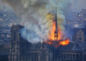 Smoke and flames rise during a fire at the landmark Notre-Dame Cathedral in central Paris on April 15, 2019, potentially involving renovation works being carried out at the site, the fire service said. - A major fire broke out at the landmark Notre-Dame Cathedral in central Paris sending flames and huge clouds of grey smoke billowing into the sky, the fire service said. The flames and smoke plumed from the spire and roof of the gothic cathedral, visited by millions of people a year, where renovations are currently underway. (Photo by Hubert Hitier / AFP)        (Photo credit should read HUBERT HITIER/AFP/Getty Images)