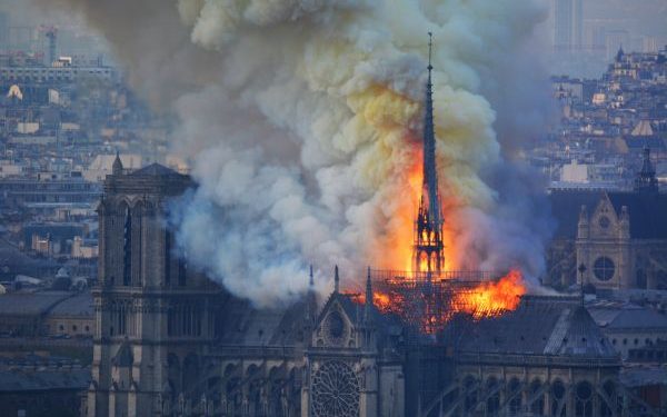 Smoke and flames rise during a fire at the landmark Notre-Dame Cathedral in central Paris on April 15, 2019, potentially involving renovation works being carried out at the site, the fire service said. - A major fire broke out at the landmark Notre-Dame Cathedral in central Paris sending flames and huge clouds of grey smoke billowing into the sky, the fire service said. The flames and smoke plumed from the spire and roof of the gothic cathedral, visited by millions of people a year, where renovations are currently underway. (Photo by Hubert Hitier / AFP)        (Photo credit should read HUBERT HITIER/AFP/Getty Images)