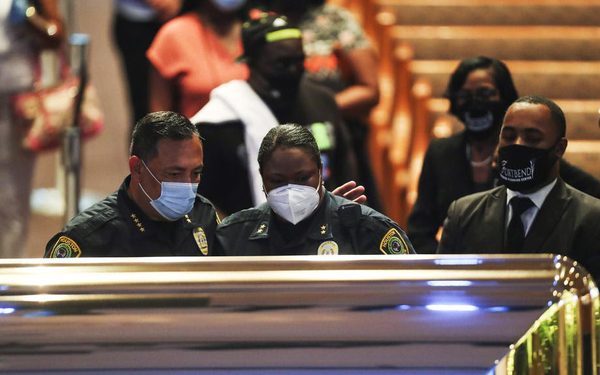 epa08473348 Houston Police Department chief Art Acevedo and assistant chief Sheryl Victorian visit the open casket during a public visitation for George Floyd at the Fountain of Praise church, in Houston, Texas, USA, 08 June 2020. A bystander's video posted online on 25 May, appeared to show George Floyd, 46, pleading with arresting officers that he couldn't breathe as an officer knelt on his neck. The unarmed Black man later died in police custody and all four officers involved in the arrest have been charged and arrested.  EPA-EFE/Godofredo A. Vasquez / POOL