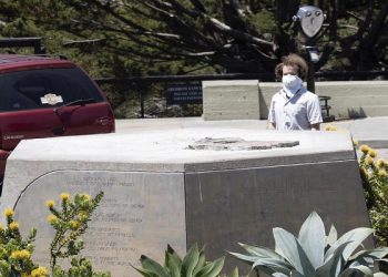 A person looks at the empty pedestal where a statue of Christopher Columbus once stood next to Coit Tower overlooking the Golden Gate Bridge and the San Francisco Bay in San Francisco, USA, 18 June 2020. San Francisco officials quietly removed the 4,000 pound statue in the early morning. For many Native Americans the statue has always been associated with slavery, subjugation, and conquest.  EPA-EFE/JOHN G. MABANGLO
