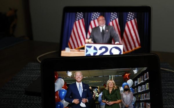 epa08611933 US Democratic president candidate for the Joe Biden (L) is displayed on a computer, after accepting the Democratic Nomination during the virtual Democratic National Convention, in New York City, 18 August 2020.  EPA-EFE/JASON SZENES