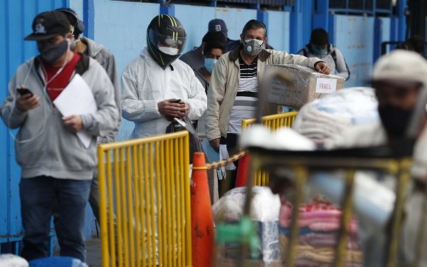 epa08548196 People await to board an inter-provincial bus in a terminal, in Lima, Peru, 15 July 2020. Peru resumed domestic travel in much of the national territory on Wednesday after four months of stoppage as a measure to stop the spread of the coronavirus. Planes and buses have been virtually out of order since the national quarantine began on 16 March and have only made a few extraordinary trips for humanitarian transfers of people who wanted to return to their home regions during confinement  EPA-EFE/Paolo Aguilar