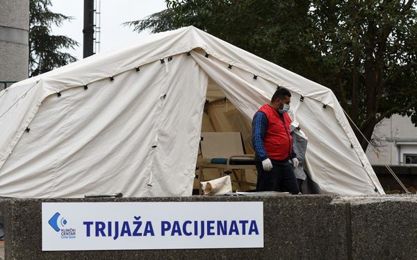 epa08326930 A worker wearing a protective face mask helps set up a pre-triage tent in front of the Clinical Center of Montenegro in Podgorica, Montenegro, 27 March 2020. Health authorities in the small Western Balkan country have reported 67 confirmed cases of the COVID-19 disease caused by the SARS-CoV-2 coronavirus, as well as one death so far.  EPA-EFE/BORIS PEJOVIC