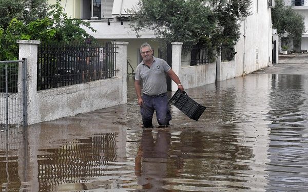 epa08680394 A man walks in a flooded street caused by the Mediterranean hurricane (Medicane) Ianos, in Orea Eleni Natural Thermal Spring, Corinth, Peloponnese, Greece, 19 September 2020. Since Ianos made landfall overnight on 17 September morning, the Fire Brigade has received a total of 2,450 throughout Greece for help and pumping out of flood water. Most calls for help came from the southern Ionian Islands, western Greece (which, along with sections of NW Peloponnese, were under a state of emergency), Central Greece and Thessaly. Several operations are still active, while the total calls include 619 completed rescues. A farmer who went missing in Karditsa, was found dead.  EPA-EFE/VASSILIS PSOMAS