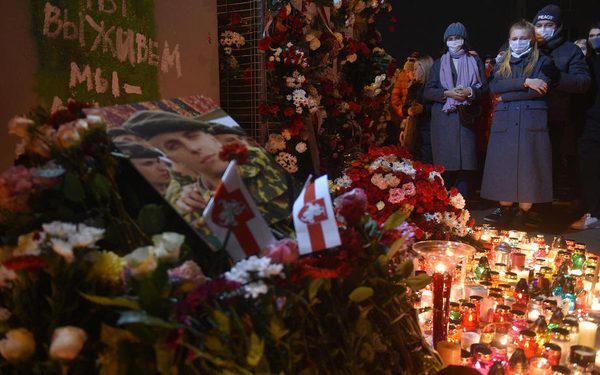 epa08816770 Belarusians bring flowers and candles with a portrait of Roman Bondarenko to a painted over mural at Change Square in Minsk, Belarus, late 12 November 2020. A 31-year-old Roman Bondarenko was reportedly injured by masked men on late 11 November in such a way that he died in hospital later.  EPA-EFE/STR