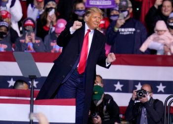 President Donald Trump moves to the song YMCA as he finishes a campaign rally at John P. Murtha Johnstown-Cambria County Airport in Johnstown, Pa., Tuesday, Oct. 13, 2020. (AP Photo/Gene J. Puskar)