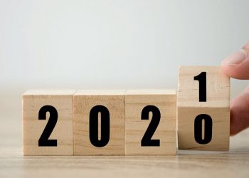Hand flipping wooden blocks for change year  2020 to 2021 . New year and holiday concept.