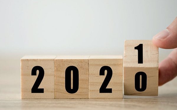 Hand flipping wooden blocks for change year  2020 to 2021 . New year and holiday concept.