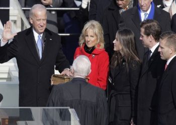 Vice President-elect Joe Biden, with his wife Jill at his side, takes the oath of office from Justice John Paul Stevens, as his wife holds the Bible at the U.S. Capitol in Washington, Tuesday, Jan. 20, 2009. At right are Biden's children Ashley, Hunter and Baeu, far right.  (AP Photo/Jae C. Hong)