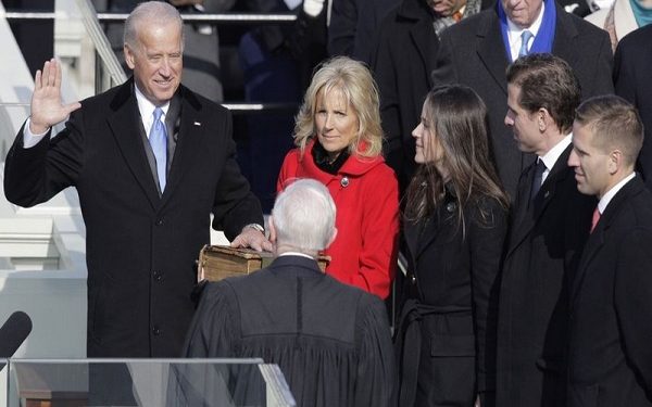Vice President-elect Joe Biden, with his wife Jill at his side, takes the oath of office from Justice John Paul Stevens, as his wife holds the Bible at the U.S. Capitol in Washington, Tuesday, Jan. 20, 2009. At right are Biden's children Ashley, Hunter and Baeu, far right.  (AP Photo/Jae C. Hong)