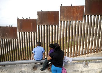 A family looks towards metal bars marking the United States border where it meets the Pacific Ocean Wednesday, March 2, 2016, in Tijuana, Mexico.  Former Mexican President Vicente Fox on Wednesday stood by his comparison of Donald Trump to Adolf Hitler, saying the Republican presidential front-runner “believes in the white supremacy.” Fox is calling on Americans to “wake up” from “this Republican nightmare.” He made the remarks Wednesday in an interview taped for Fox News Channel’s “Hannity.” Trump has angered many Mexicans for his campaign rhetoric denigrating some immigrants as "rapists" who bring crime and drugs to the United States, and his promise to build a wall along the entire US-Mexico border.  (AP Photo/Gregory Bull)