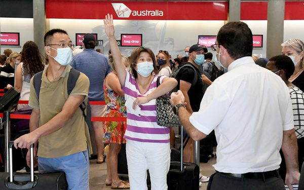 epa09104395 A passenger reacts as she attempts to check in for a flight from the domestic airport in Brisbane, Autralia, 29 March 2021. Greater Brisbane will enter a snap three-day lockdown as its coronavirus outbreak continues to grow.  EPA-EFE/DAVE HUNT AUSTRALIA AND NEW ZEALAND OUT