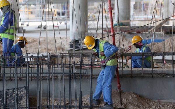 Migrant labourers work on a construction site on October 3, 2013 in Doha in Qatar. Qatar, the 2022 World Cup host is under fire over claims of using forced labour.        (Photo credit should read KARIM JAAFAR/AFP/Getty Images)