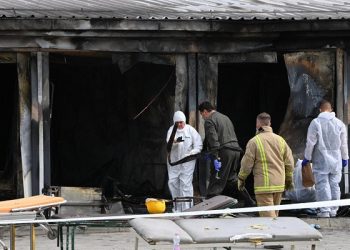 epa09456826 Investigators at the scene following a fire at a hospital for Covid-19 patients in Tetovo, Republic of North Macedonia, 09 September 2021. At least fourteen deaths have been reported by the Ministry of Health when a fire, thought to have been triggered by oxygen cylinders that provide oxygen to patients with a more severe clinical case of Covid-19, broke out at the hospital.  EPA-EFE/Georgi Licovski