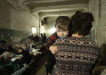 A woman holds a child in an improvised bomb shelter in Mariupol, Ukraine, Monday, March 7, 2022. (AP Photo/Mstyslav Chernov)