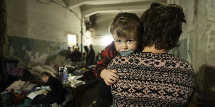 A woman holds a child in an improvised bomb shelter in Mariupol, Ukraine, Monday, March 7, 2022. (AP Photo/Mstyslav Chernov)