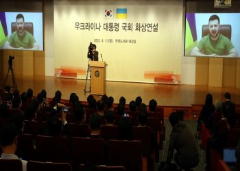 epa09884171 Ukrainian President Volodymyr Zelensky (on screen) addresses the National Assembly via video link to Seoul, South Korea, 11 April 2022. Zelensky asked South Korea to provide military hardware support to help his country fight against the Russian aggression.  EPA-EFE/YONHAP / POOL SOUTH KOREA OUT
