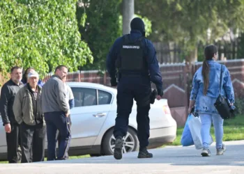 A masked policeman secures an area in the village of Dubona near the town of Mladenovac, about 60 kilometres (37 miles) south of Serbia's capital Belgrade, on May 5, 2023, in the aftermath of a drive-by shooting. - Police arrested a suspected gunman responsible for killing eight people and injuring 13 others, state media reported early on May 5, 2023, following an hours-long manhunt throughout the night in the country's second mass shooting this week. (Photo by ANDREJ ISAKOVIC / AFP)