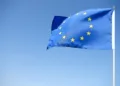 Waving European Union Flag on the blue background