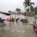 A man salvages a cart and other material as water flows on to the Kuakata beach on the coast of Bay of Bengal caused by the advancing Cyclone Remal in Barisal, Bangladesh, Sunday, May 26, 2024. (AP Photo/Abdul Goni)